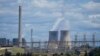 FILE - The Liddell Power Station, left, and Bayswater Power Station, coal-powered thermal power stations, are pictured near Muswellbrook in the Hunter Valley, Australia, Nov. 2, 2021. 